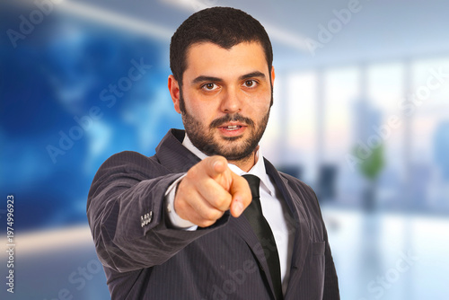 Focused man points forward with confident expression