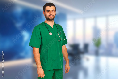 Young doctor stands confidently in green scrubs