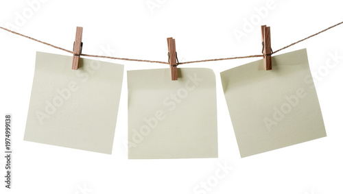 Foto Isolated three empty light yellow square memo notes hanging on a clothesline with wooden pins