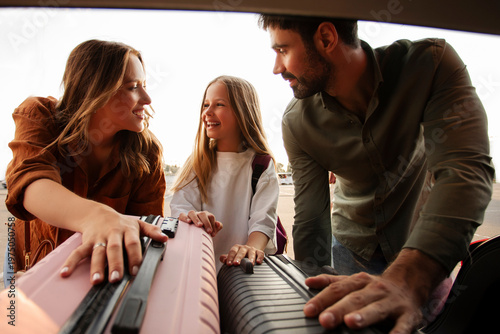 Foto European family enjoying moment loading their luggage into the trunk of car, pre