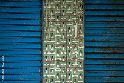 Wall with blue metal texture and traditional tiles pattern