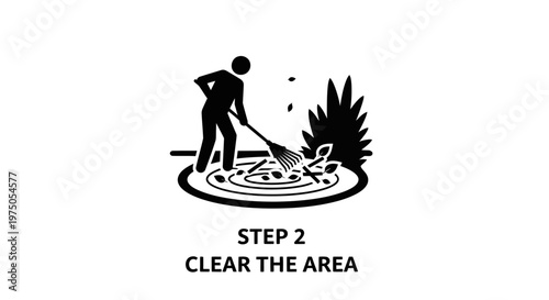 Man clearing leaves with a rake.