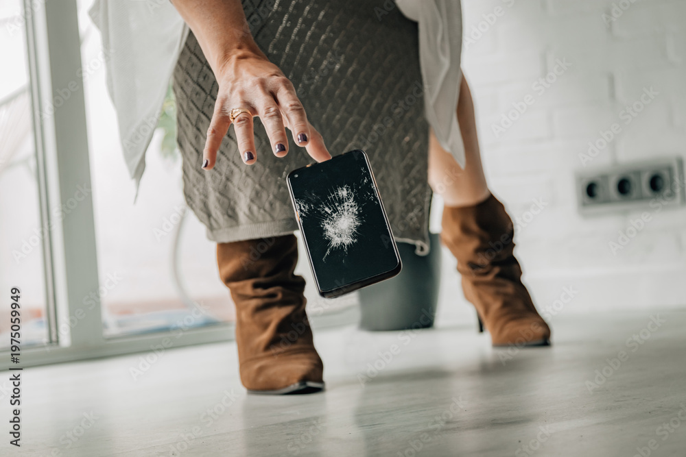 Fototapeta premium woman and falling broken mobile phone