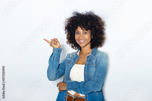 young woman with afro hair isolated on background pointing