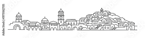 Cluster of small houses and bell tower on coastal hillside