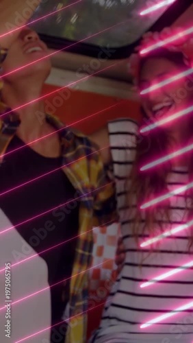 Vertical video: Phone tap starting crew fixing crown and hat, leaning and posing for neon selfie