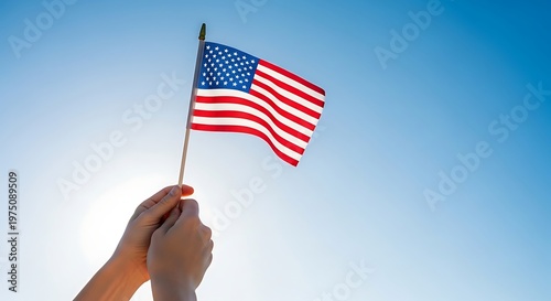 Hand Holding Waving American Flag Against Blue Sky, Patriotic Freedom Concept, Independence Day Celebration, 4th of July Spirit, USA Pride Symbol, Outdoor Scene with Sunlight