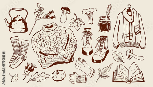 Autumn clothing and accessories arranged with seasonal items on a table indoors