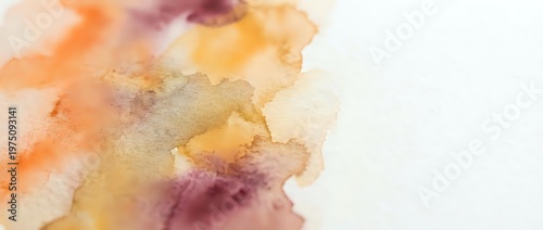 Abstract watercolor background with warm orange yellow purple paint blends flowing organically across white paper creating soft artistic texture for creative projects.