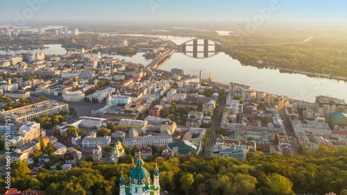 Wallpaper Mural St. Andrew's Church on the hill in Podil district of Kyiv, beautiful aerial hyper lapse of Kiev city at sunrise. Golden morning sun rays over historic center of Kyiv, Dnieper river and bridges Torontodigital.ca