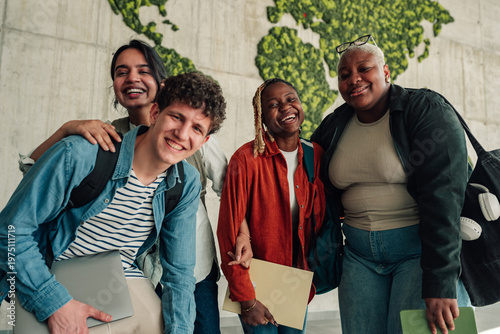 Diverse students smiling, standing together in front of a green world map, symbolizing global education and unity