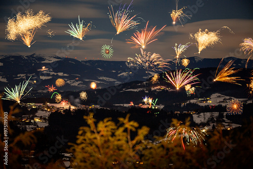 New Years firework at new years day in front of snowy mountains.
