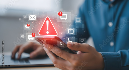 Person holding a smartphone displaying a critical warning sign and various notification icons, indicating potential digital security threats.
