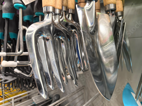 Shiny gardening tools hanging in a colorful display at the local store