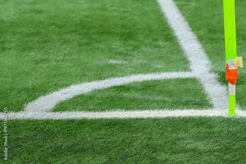 Fotografía soccer field with green grass, white markings, and a corner flag