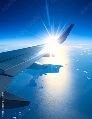 A vibrant shot of an airplane wing slicing through a bright blue sky, the sun positioned just over the wing's edge