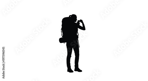 A traveler with a backpack pauses to take a photo silhouette