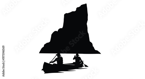 Two people canoeing near a rocky outcrop a striking silhouette