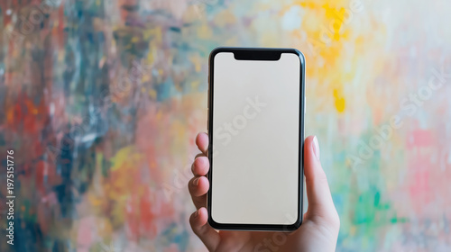 Female hand holding smartphone with blank screen against colorful abstract background