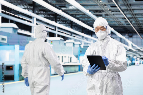 QC engineer inspecting semiconductor production infrastructure, optimizing photolithography process. Scientist doing RD on silicon wafers in research facility, trialing advanced materials