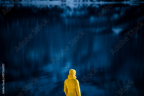 Lone traveler in Tromso Norway with blurred fjord backdrop