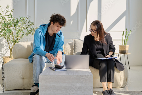 Psychological session therapy, young guy and therapist looking at computer together