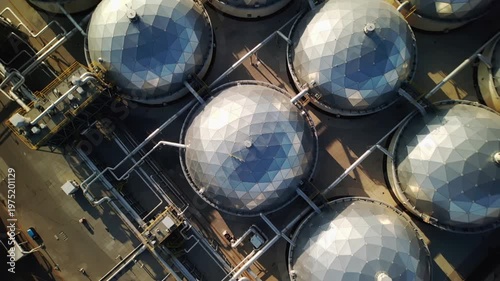 Industrial storage tanks at refinery facility, aerial view showing geometric dome structures