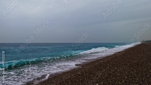 Beautiful waves and cloudy sky on beach in spring
