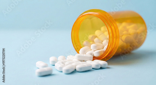 White Pills Dispensing from Amber Bottle Healthcare Concept