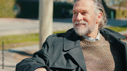 Senior Man Smiling Outdoors In Coat And Sweater