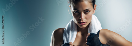 Fit Athletic Woman with Towel and Hand Wraps Ready to Fight