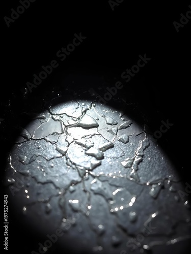 Obsidian-like polished silver surface etched with light, revealing intricate crystalline facets under harsh spotlight,  element,  fractal