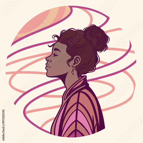 Profile portrait of a woman with curly hair bun.