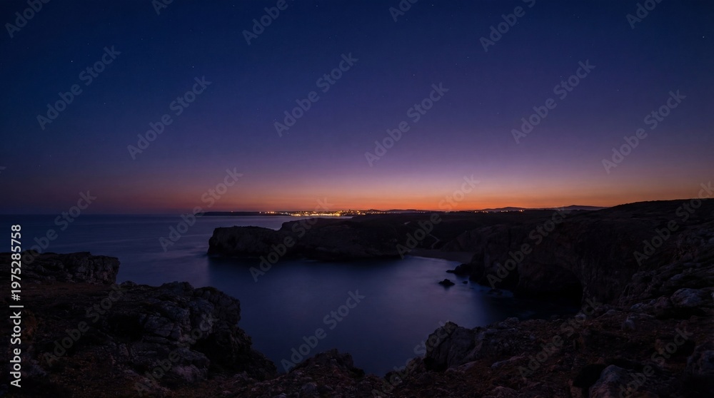 Fototapeta premium Boy stands in tall grass looking at night stars concept. Stunning twilight view of a calm ocean and rocky coastline.