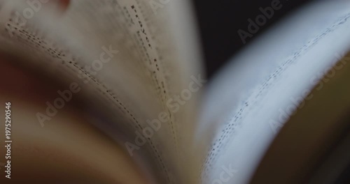 Extreme Close-up of a man's finger reading and scrolling through a prayer book
