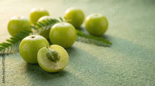 Fresh Amla Indian Gooseberries with Cut Fruit Showing Seed on Linen Fabric, Natural Vitamin C Rich Superfood for Immunity, Healthy Eating and Ayurvedic Wellness Concept
