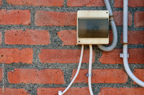 old brick wall with electric plug