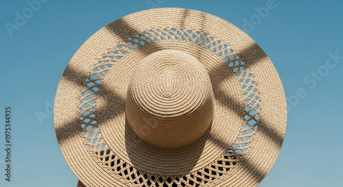 Wide-brimmed straw hat with shadow under clear blue sky - Summer Vacation Concept