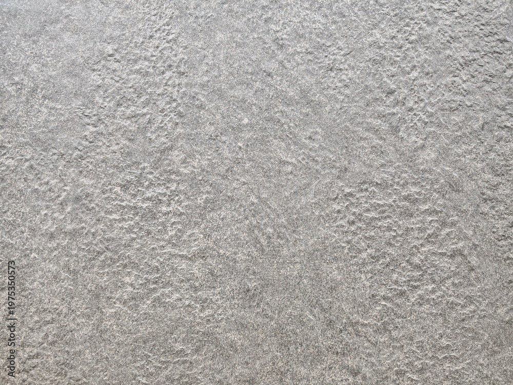 Fototapeta premium High-resolution grey concrete background with fine natural grain. Raw cement plaster texture for architectural design, urban themes, and modern interior backdrop.