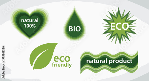 Set of green eco-friendly labels and icons including natural 100 percent, bio, and eco friendly text with leaf, heart, and droplet shapes.