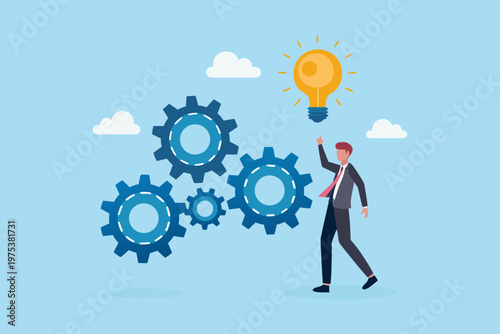 A businessman reaching for a bright lightbulb amidst interconnected gears