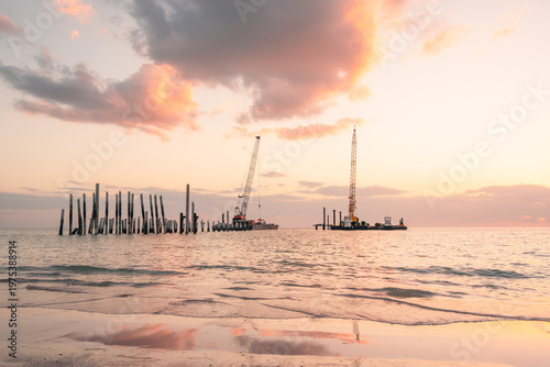 Floating construction equipment in place to rebuild Naples Pier that was destroyed by Hurricane Ian in Florida in 2022