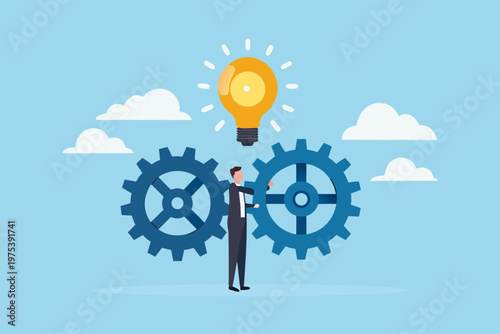 A businessman activates a lightbulb connected to turning gears