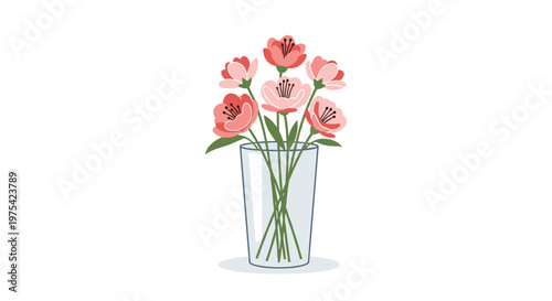 Elegant bouquet of pink and coral flowers in a clear glass vase provides a beautiful floral decoration for interiors and gift cards.