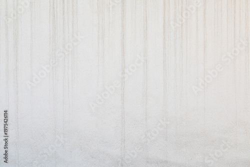 minimalist white plaster wall texture with vertical liquid drip marks