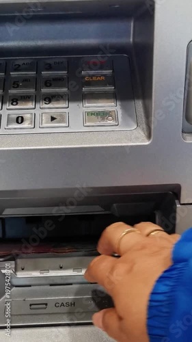 Close-up of ATM cash withdrawal with Indonesian rupiah notes