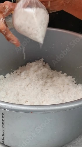 Packing Freshly Grated Coconut Meat into Plastic Bags at a Traditional Market