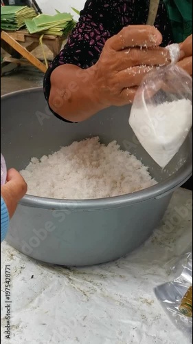Traditional market preparation of grated coconut being packed into plastic bags