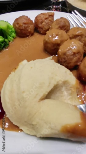 Enjoy Swedish Meatballs with Mashed Potatoes, Broccoli, and Cranberry Sauce