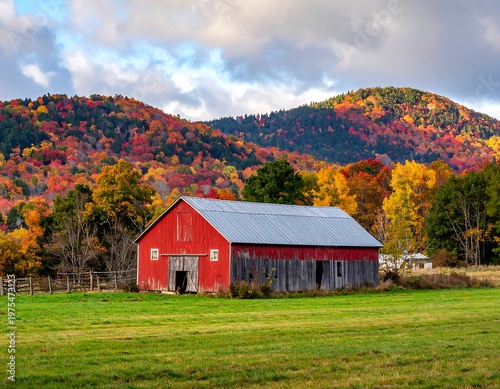 A vivid red barn nestled in a landscape of autumn colors